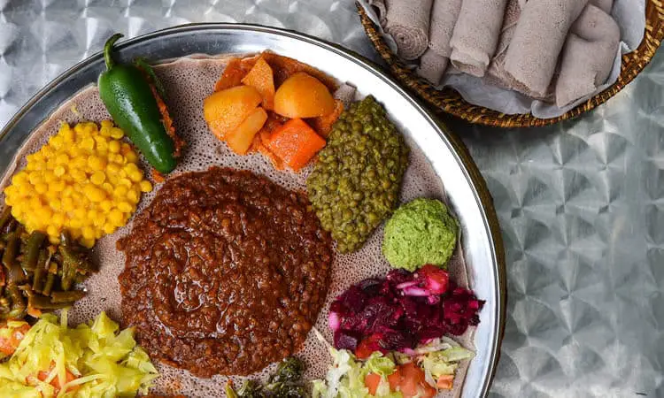 Spice filled curries, vegetables, lots of meat, and Injera, make up Ethiopian’s local cuisine.